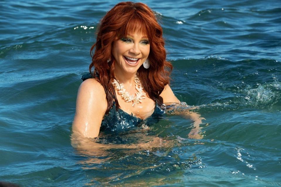 Reba McEntire appears as the water spirit Trish, saving the day in "Barb & Star Go to Vista Del Mar."