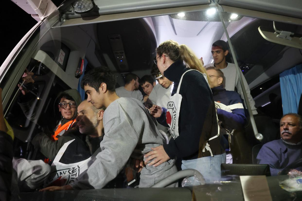 Palestinian prisoners freed from the Ofer Israeli military prison disembark from a bus as they return to Beitonia, near Ramallah, West Bank (EPA)