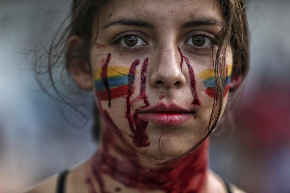 A student performs a play called "Who killed them" during anti-government protests in Cali, Colombia, Tuesday, May 11, 2021. Colombians have protested across the country against a government they feel has long ignored their needs, allowed corruption to run rampant and is so out of touch that it proposed tax increases during the coronavirus pandemic. (AP Photo/Andres Gonzalez)