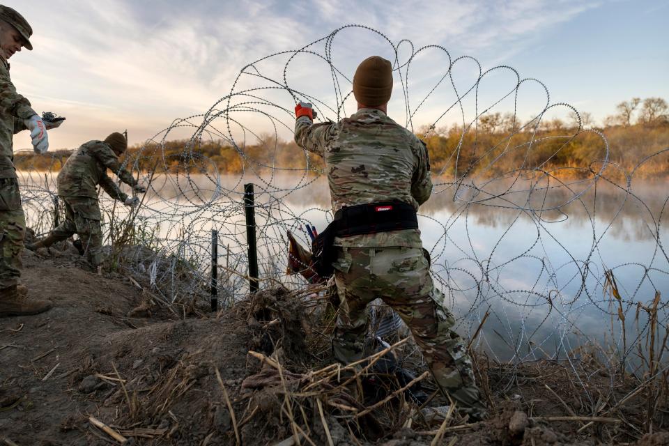 Texas National Guard soldiers install additional razor wire along the Rio Grande on January 10, 2024 in Eagle Pass, Texas.