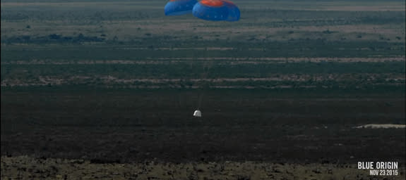 Blue Origin's New Shepard space capsule floats back to Earth under parachutes after a successful unmanned suborbital test flight from the company's West Texas facility on Nov. 23, 2015.