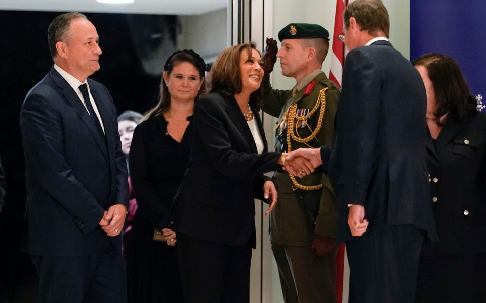 Vice President Kamala Harris shakes hands with Charles Roxburgh, permanent secretary of HM Treasury - AP