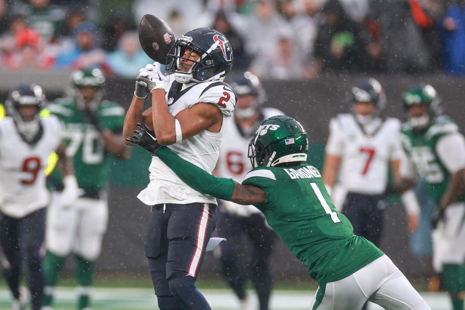 Dec 10, 2023; East Rutherford, New Jersey, USA; New York Jets cornerback Sauce Gardner (1) breaks up a pass intended for Houston Texans wide receiver Robert Woods (2) during the first half at MetLife Stadium.