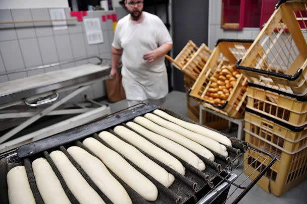 PHOTO: A baker prepares loaves of baguette bread in a bakery in Brou near Chartres, southwest of Paris, on Dec. 1, 2022. (Julien De Rosa/AFP via Getty Images)