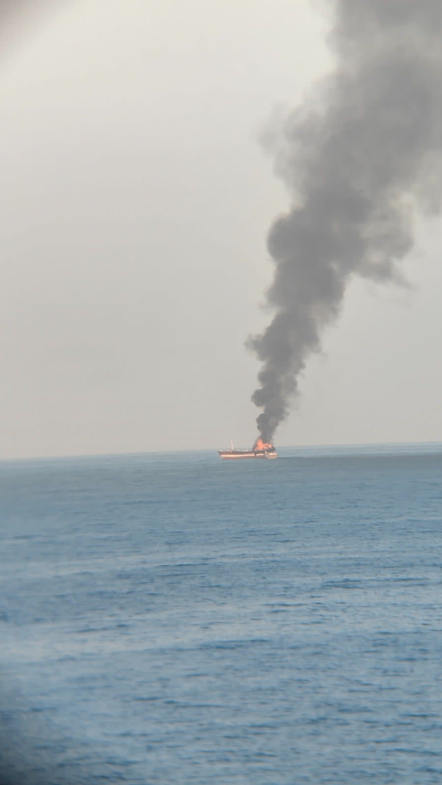 The <em>CMA CGM Symi</em> cargo vessel burning in the Indian Ocean after a suspected Houthi drone attack. (Ambrey photo)
