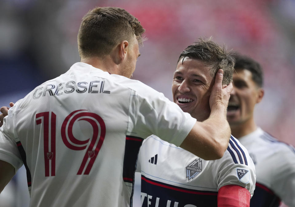 Vancouver Whitecaps' Ryan Gauld, right, and Julian Gressel (19) celebrate Gauld's first goal against the Los Angeles Galaxy during the first half of an MLS soccer match Saturday, July 15, 2023, in Vancouver, British Columbia. (Darryl Dyck/The Canadian Press via AP)