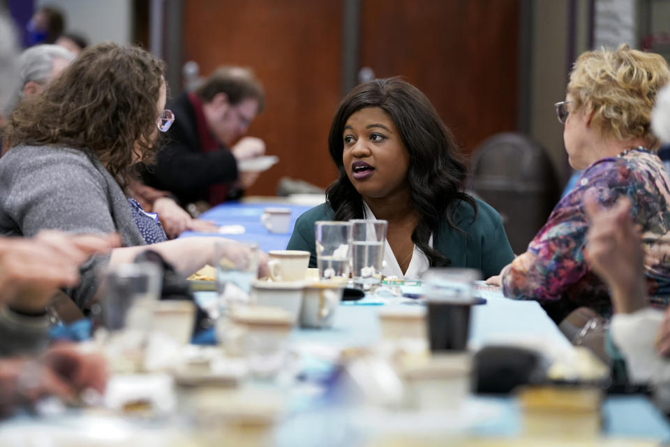 Iowa Democratic gubernatorial candidate Deidre DeJear, center, speaks to local residents during the Story County Democrats Super Soup Fundraiser, Saturday, March 12, 2022, in Nevada, Iowa. (AP Photo/Charlie Neibergall)