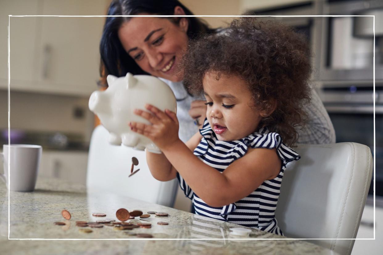  Mother and child getting money from a piggy bank 