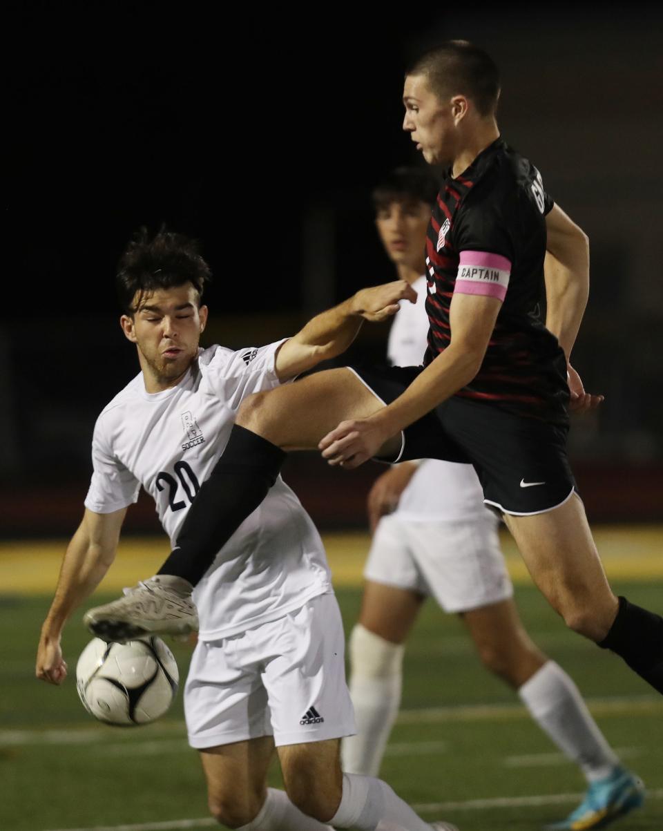 From left, Byram Hills Zach Pero (20) and Rye's Tommy Broderick (20) battle for ball control during the Class A Section 1 finals at Lakeland High School in Shrub Oak Oct. 28, 2023.