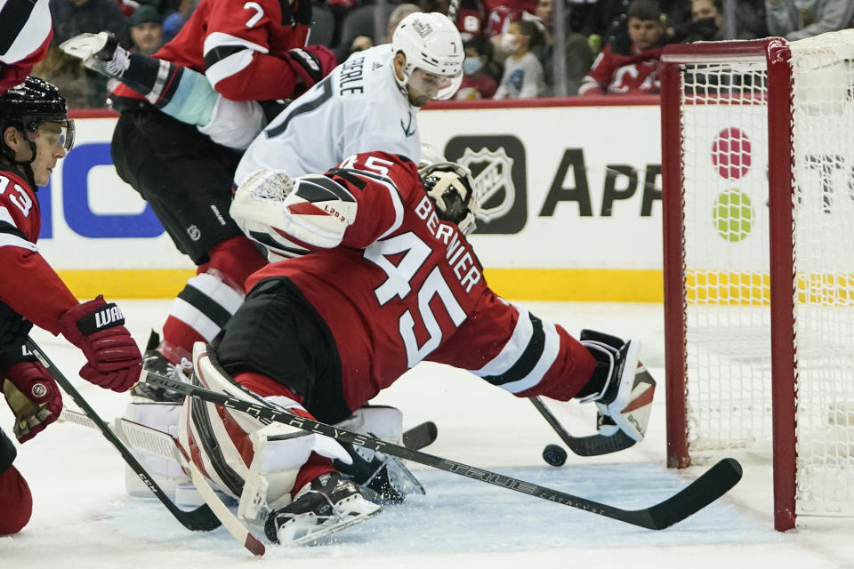 New Jersey Devils goaltender Jonathan Bernier (45) stops a shot by Seattle Kraken's Jordan Eberle (7) during the second period of an NHL hockey game Tuesday, Oct. 19, 2021, in Newark, N.J. (AP Photo/Frank Franklin II)