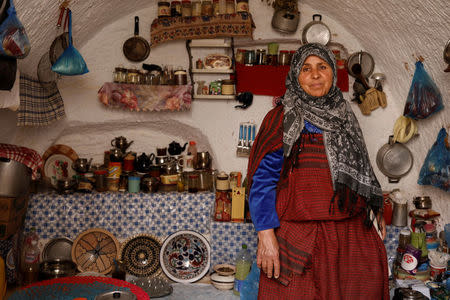 Mounjia, 60, poses for photograph in the kitchen of her troglodyte house in Matmata, Tunisia, February 6, 2018. "I don't want to leave my troglodyte house for a modern one, we could buy everything but not peace of mind," Mounjia said. REUTERS/Zohra Bensemra