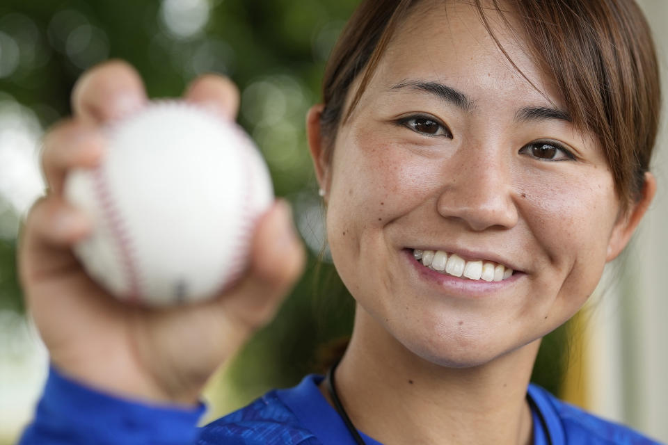 Eri Yoshida of a Japanese women's baseball team, Agekke, shows her knuckleball grip during an interview in Oyama, Tochigi prefecture, north of Tokyo, Tuesday, May 30, 2023. The 31-year-old Japanese woman is a knuckleball pitcher with a sidearm delivery that she hopes might carry her to the big leagues in the United States or Japan. (AP Photo/Shuji Kajiyama)