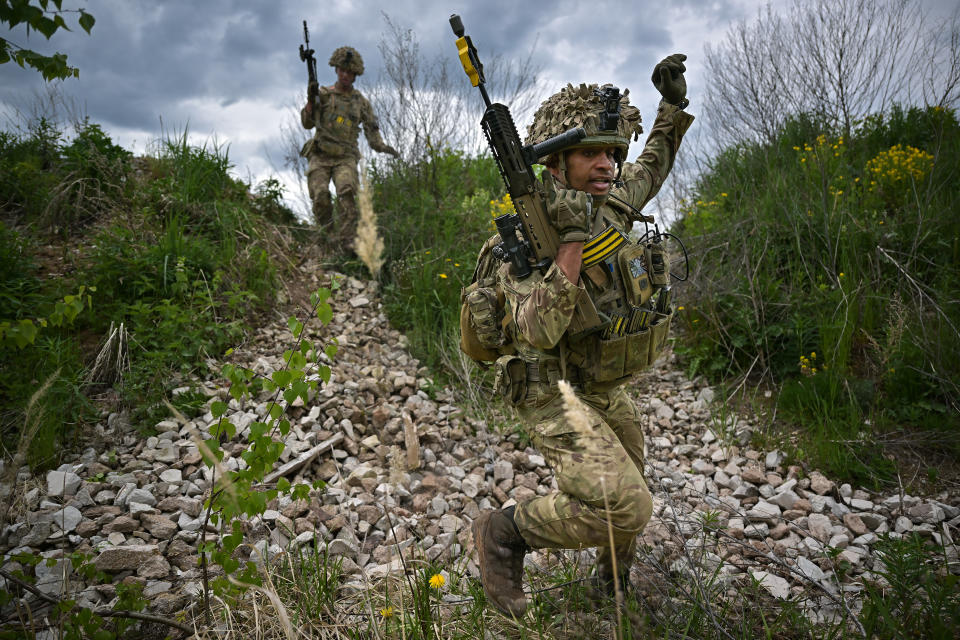 Soldiers from the Royal Welsh Battlegroup participate in maneuvers during NATO's Exercise Hedgehog on the Estonian-Latvian border in 2022. 