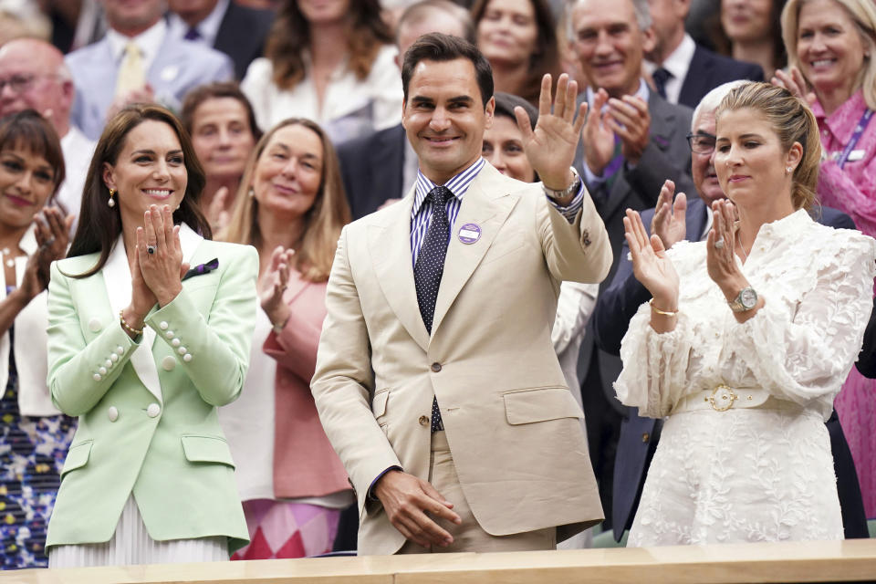 Britain's Kate, Princess of Wales, left, stands in the royal box with tennis champion Roger Federer and his wife Mirka, on day two of the Wimbledon tennis championships in London, Tuesday, July 4, 2023. (Adam Davy/PA via AP)