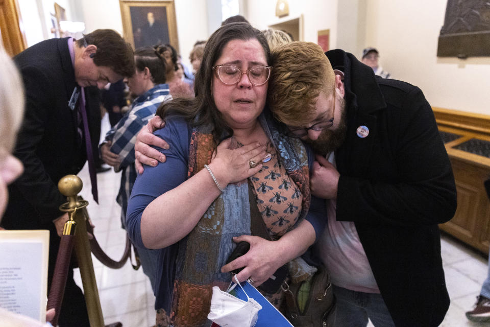 Christine Cox, center, a parent of a transgender teenager, becomes emotional after speaking to state Sen. Carden Summers, R-Cordele, rear left, outside the Senate at the Capitol in Atlanta on Monday, March 20, 2023. Activists appeared at the Capitol to protest SB 140, a bill sponsored by Summers that would prevent medical professionals from giving transgender children certain hormones or surgical treatment. (Arvin Temkar/Atlanta Journal-Constitution via AP)