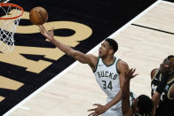 Milwaukee Bucks forward Giannis Antetokounmpo (34) releases a shot against the Atlanta Hawks during the first half of an NBA basketball game Thursday, April 15, 2021, in Atlanta. (AP Photo/John Bazemore)