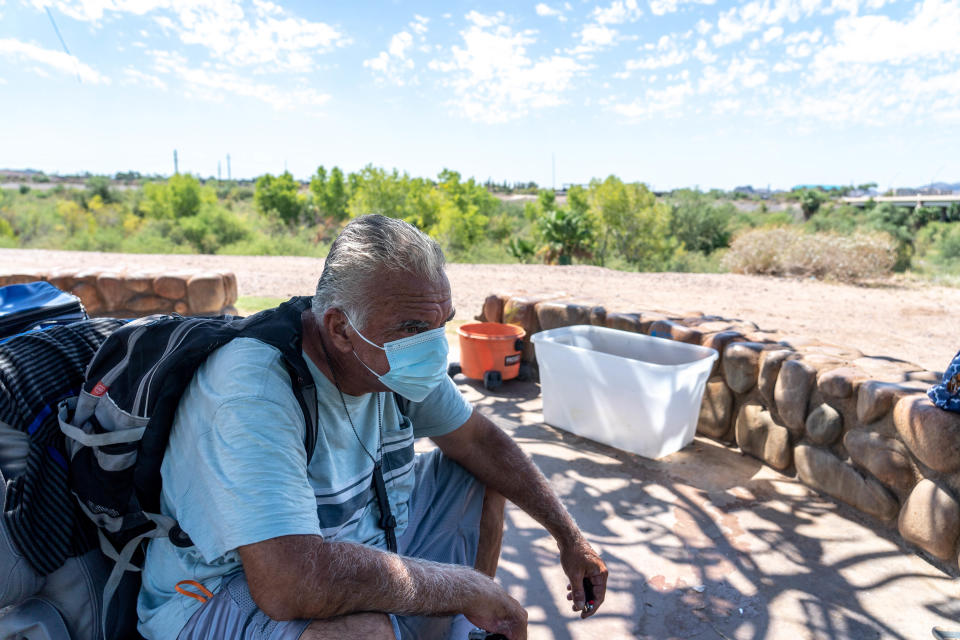 Michael Holden, 55, who has been living along the Rio Salado riverbed, sits in shade under a tree in Tempe on Aug. 31, 2022. Tempe gave notice for people living in the river bottom to vacate by Aug. 31.