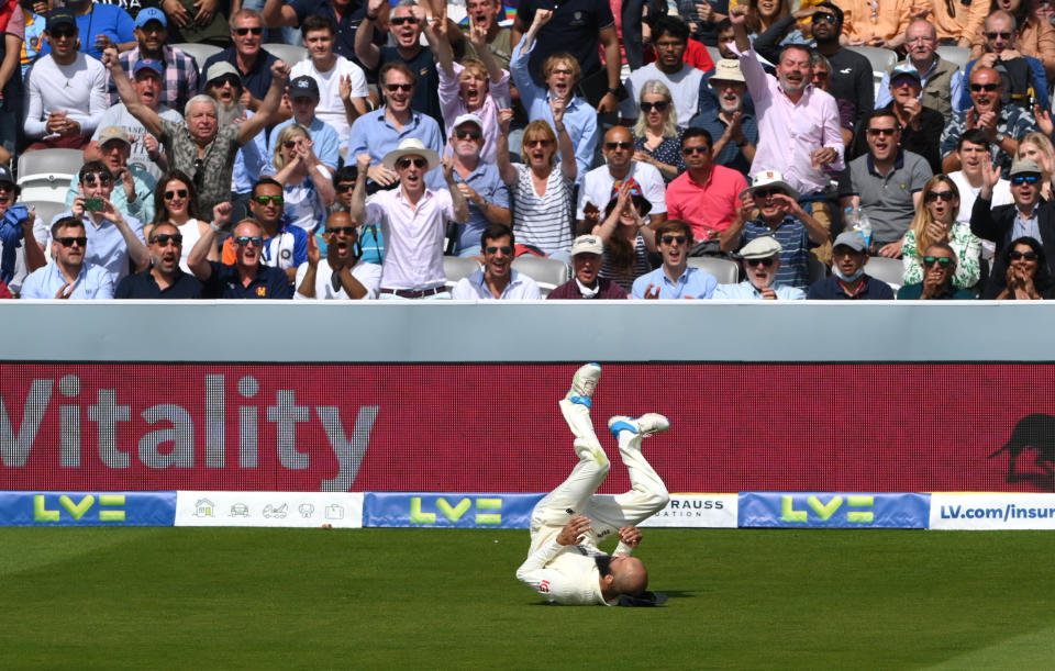 LONDON, ENGLAND - AUGUST 15: England fielder Moeen Ali takes the catch to dismiss Rohit Sharma off bowler Mark Wood during day four of the Second Test Match between England and India at Lord's Cricket Ground on August 15, 2021 in London, England. (Photo by Stu Forster/Getty Images)