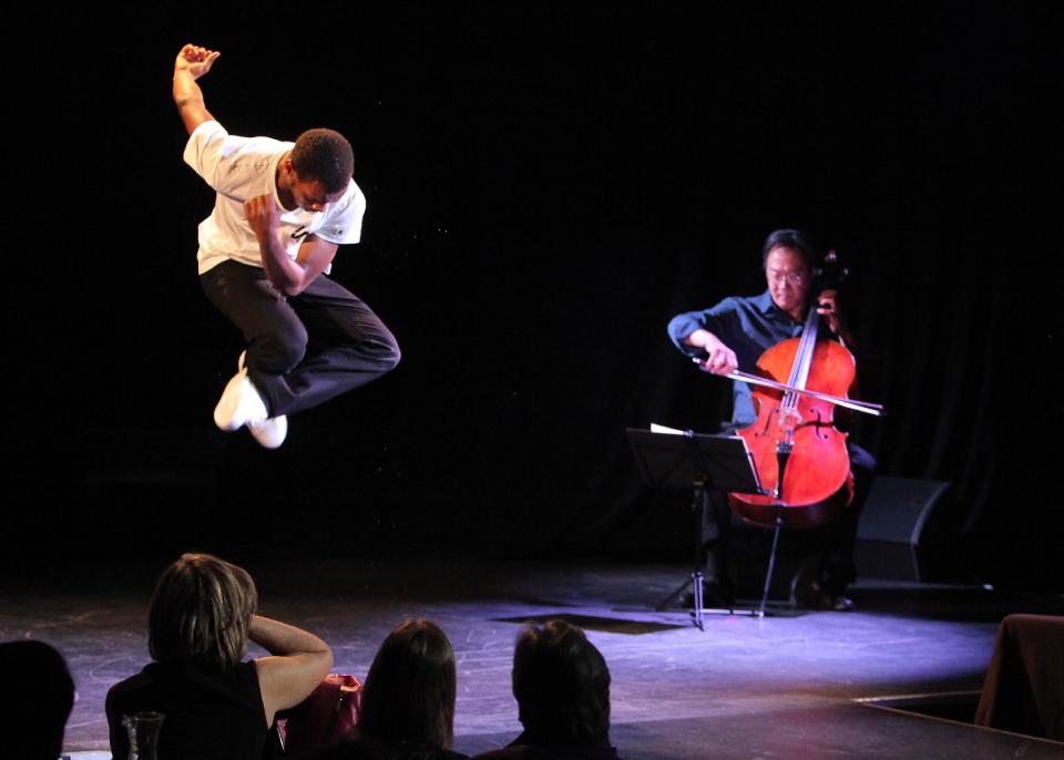 This April 2, 2013 photo released by New York City Center shows Lil Buck, left, performing with Yo-Yo Ma, at Poisson Rouge nightclub in New York. (AP Photo/New York City Center, Erin Baiano)