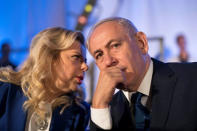 Israeli Prime Minister Benjamin Netanyahu and his wife Sarah Netanyahu attend an event marking the 50th anniversary of Israel's capture of East Jerusalem during the 1967 Six-Day War, opposite the Old City wall and near the Tower of David in Jerusalem May 21, 2017. REUTERS/Abir Sultan/Pool