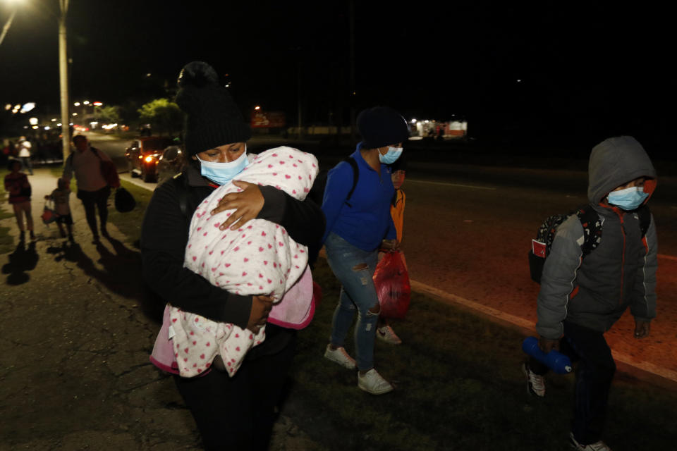 Members of a migrant caravan begin their journey in the hopes of reaching the United States, in San Pedro Sula, Honduras, Saturday, Jan. 15, 2022. (AP Photo/Delmer Martinez)