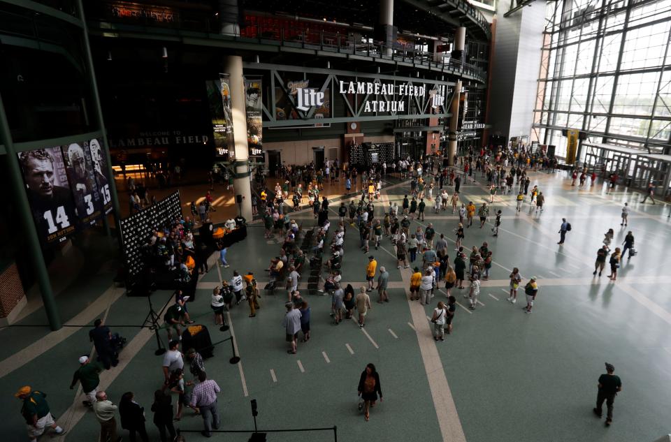 Green Bay Packers shareholders and guests mill about the atrium before the start of the annual meeting on July 24, 2023, in Green Bay, Wis.