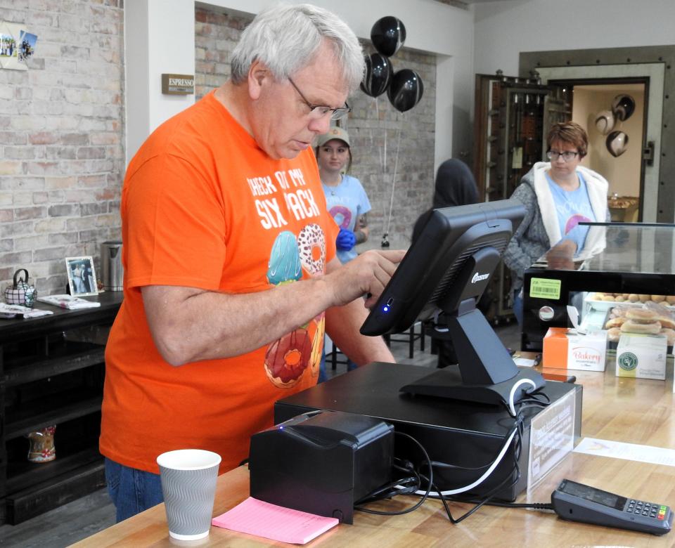 Deric Potts inputs items into a register at Heavenly Sweets Bakery in West Lafayette. The Coshocton outlet opened in November and a shop in Mount Vernon could be in the future.