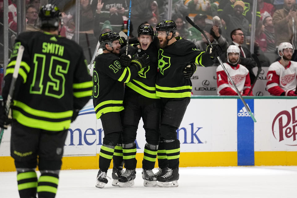Dallas Stars' Craig Smith (15), Sam Steel, Esa Lindell and Jani Hakanpaa, right, celebrate after Lindell scored in the first period of an NHL hockey game against the Detroit Red Wings in Dallas, Monday, Dec. 11, 2023. (AP Photo/Tony Gutierrez)