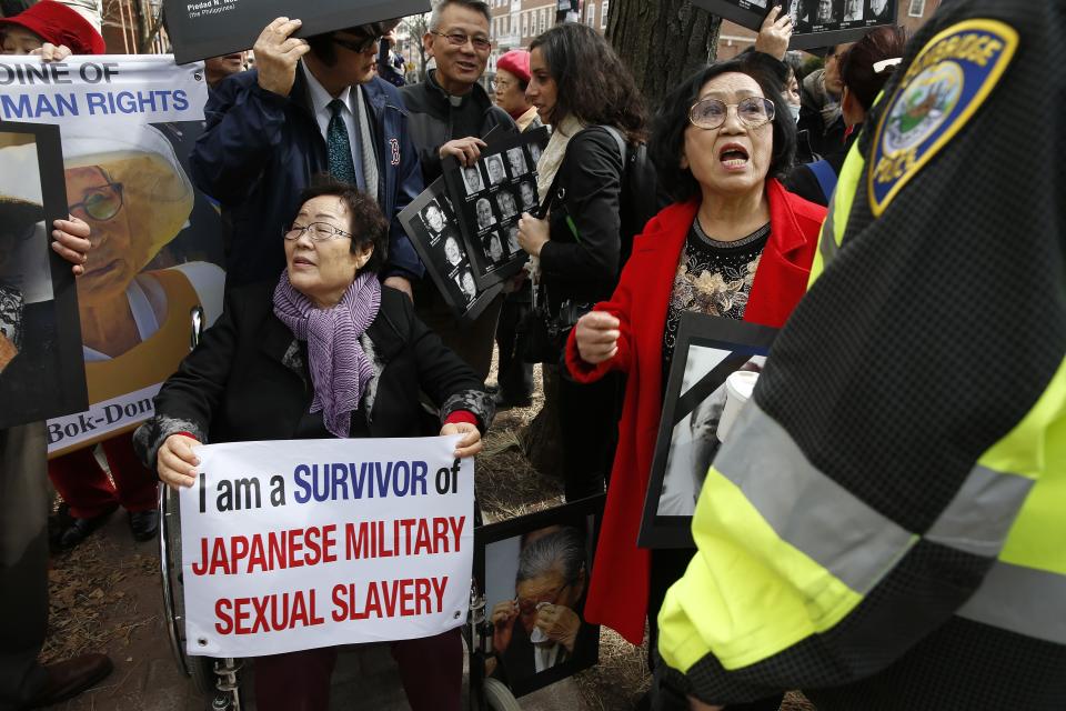 FILE - Lee Yong-soo, a South Korean sexual slavery survivor who has been demanding since the early 1990s that the Japanese government fully accept culpability and offer an unequivocal apology, participates in a protest outside the John F. Kennedy School of Government in Cambridge, Mass., where Japanese Prime Minister Shinzo Abe spoke, Monday, April 27, 2015. (AP Photo/Michael Dwyer, File)