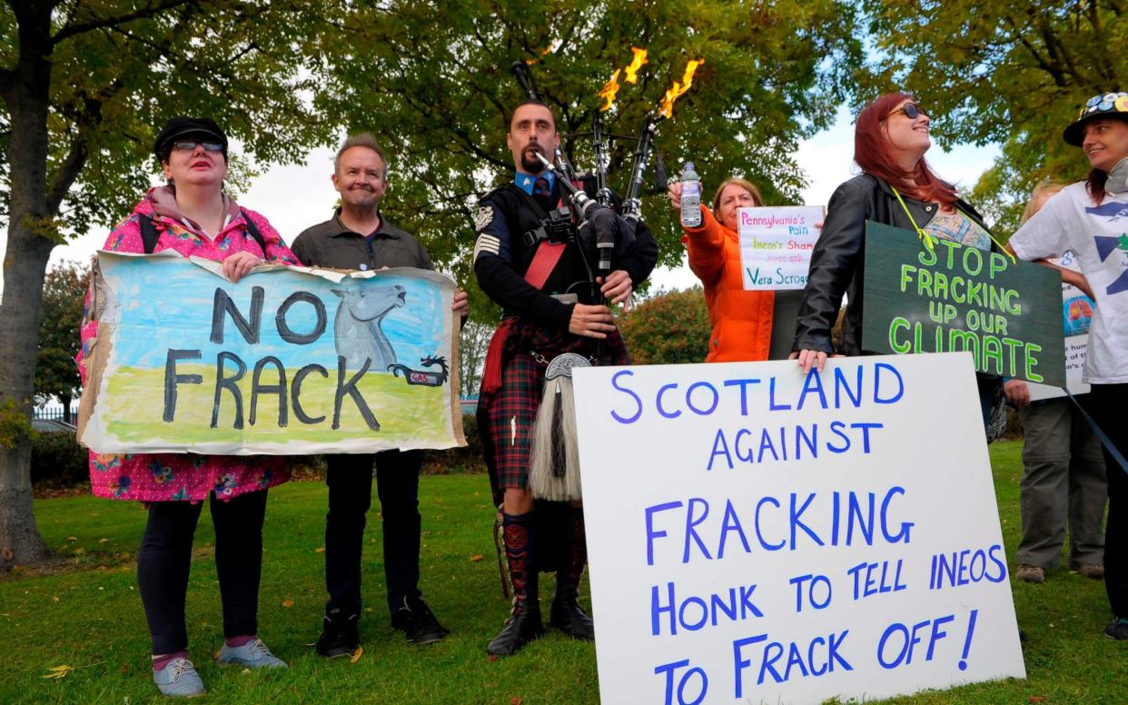 Demonstrators protesting against fracking outside Grangemouth as the first shipment of shale gas from the United States arrived in Britain - AFP