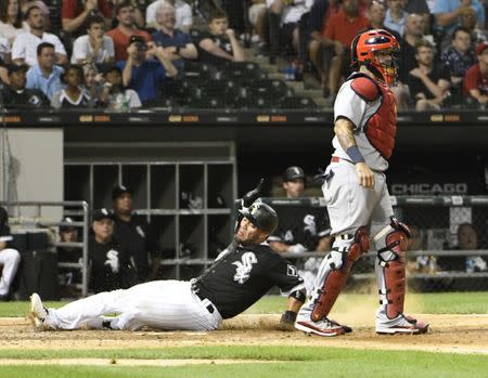 Jul 11, 2018; Chicago, IL, USA; Chicago White Sox second baseman Yoan Moncada (10) is safe at home as St. Louis Cardinals catcher Yadier Molina (4) stands nearby at Guaranteed Rate Field. Mandatory Credit: David Banks-USA TODAY Sports