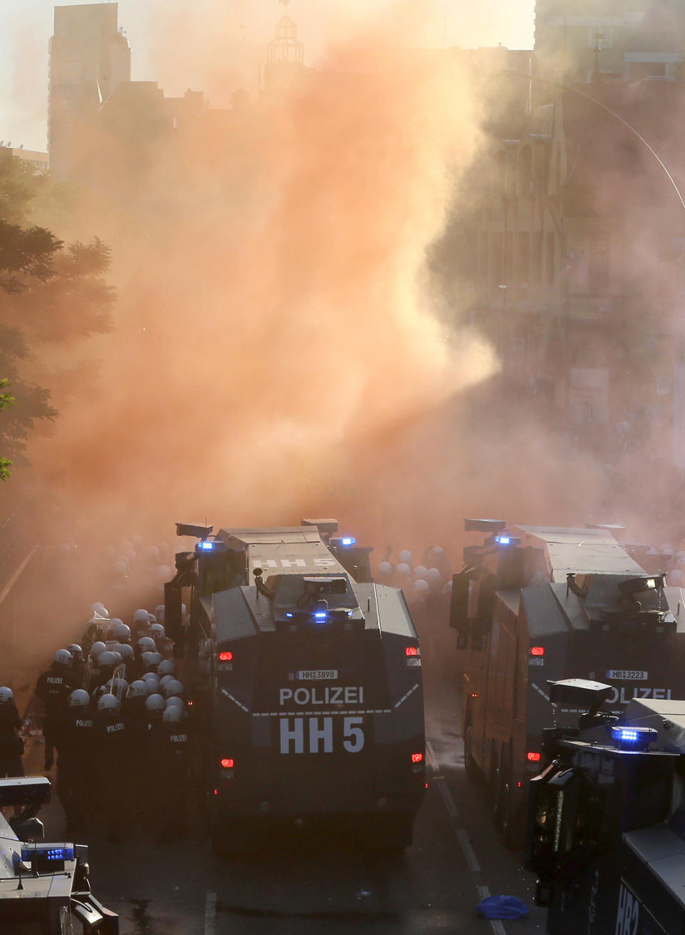 <p>Police officers stay next to water canons during a protest against the G-20 summit in Hamburg, northern Germany, July 6, 2017. The leaders of the group of 20 meet July 7 and 8. (Photo: Michael Probst/AP) </p>