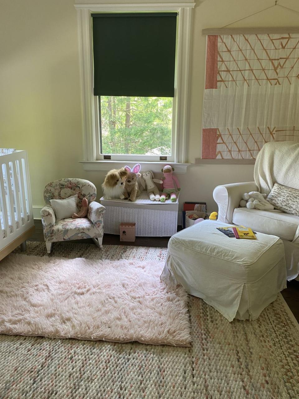 a room with a crib and a couple of stuffed animals