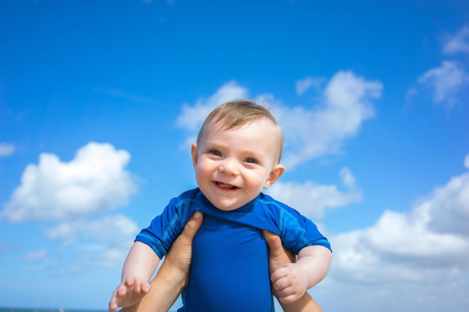 Baby boy against blue sky