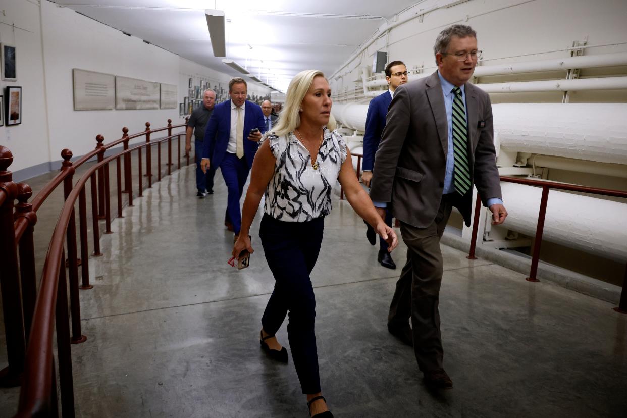 Marjorie Taylor Greene and Thomas Massie walk through the US Capitol to Speaker Mike Johnson’s office on 6 May 2024. Ms Greene is meeting with Mr Johnson on Monday afternoon about her efforts to oust him (Getty Images)