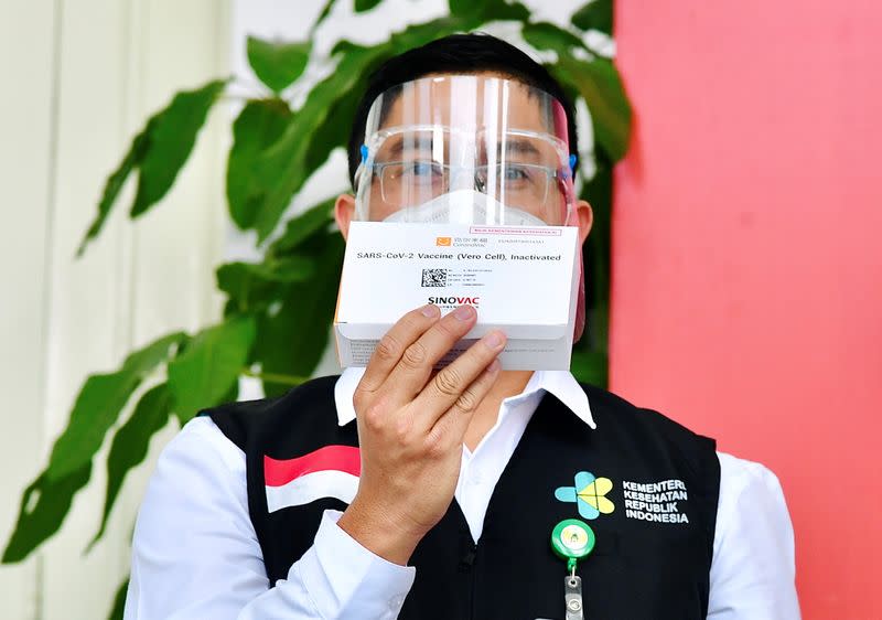 Indonesian Health Ministry official shows a package of COVID-19 vaccine in Jakarta