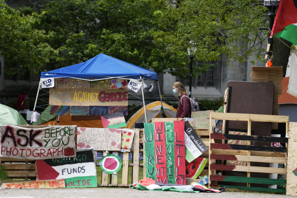 A student walks in a pro-Palestinian encampment at Main Quadrangle on the University of Chicago campus Monday, May 6, 2024, in Chicago. (AP Photo/Nam Y. Huh)