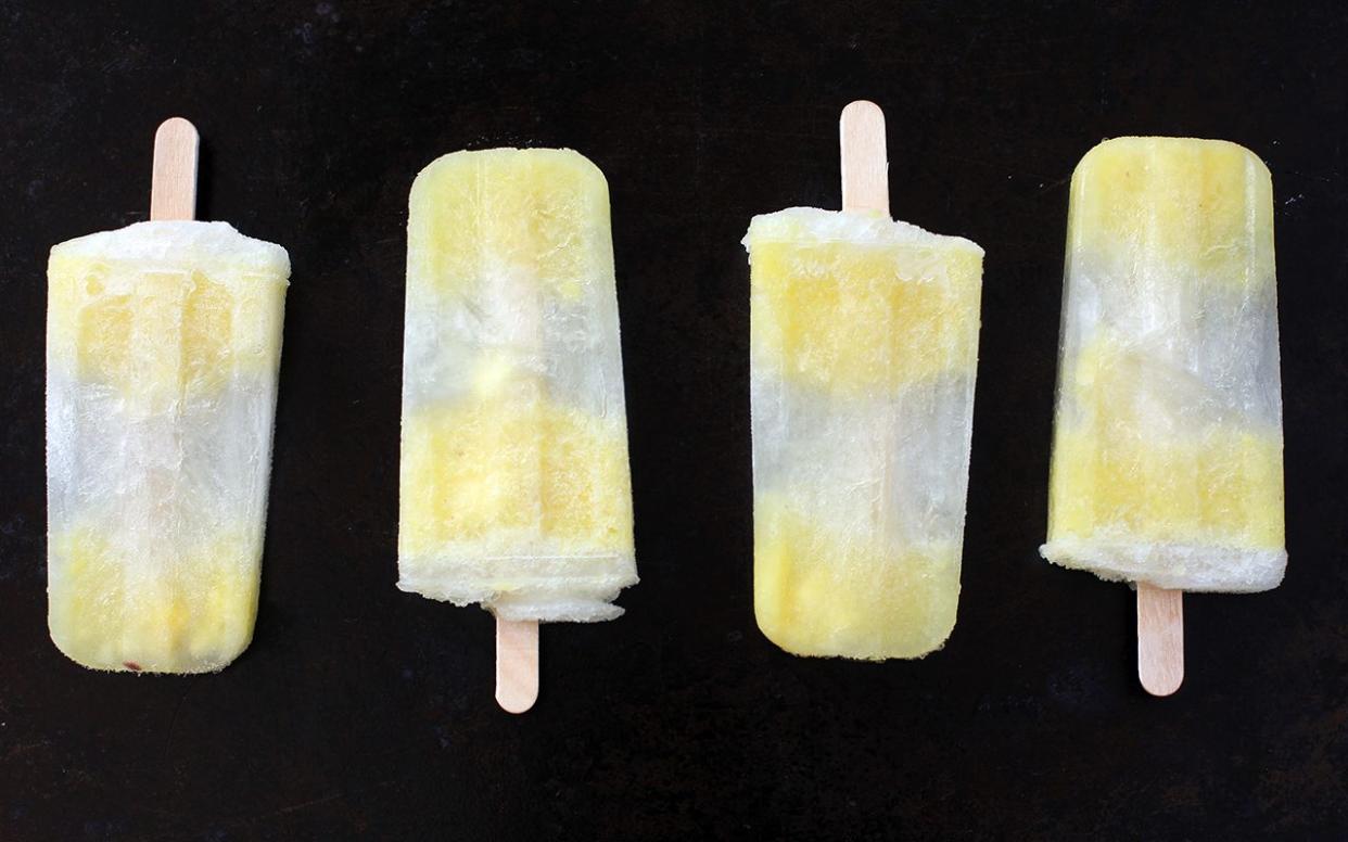 pineapple popsicles on dark background in straight line