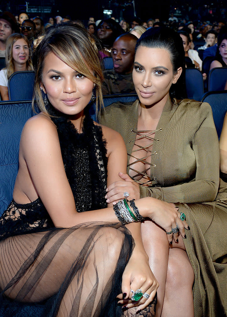 Friends Chrissy Teigen and Kim Kardashian commiserate about mom life; they don't judge. (Photo: Getty)