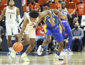 Virginia guard Reece Beekman (2) steals the ball from Pittsburgh guard Onyebuchi Ezeakudo (31) during an NCAA college basketball game in Charlottesville, Va., Friday, Dec. 3, 2021. (AP Photo/Andrew Shurtlef