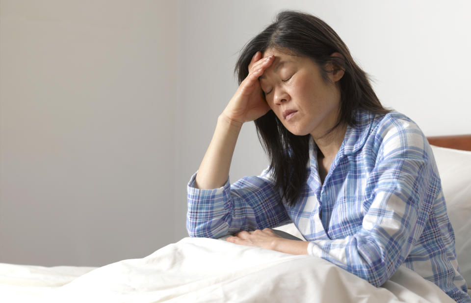 A woman looking fatigued in bed