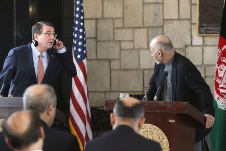 U.S. Secretary of Defense Ash Carter (L) listens to remarks by Afghan President Ashraf Ghani (R) during a joint news conference at the Presidential Palace in Kabul February 21, 2015. REUTERS/Jonathan Ernst