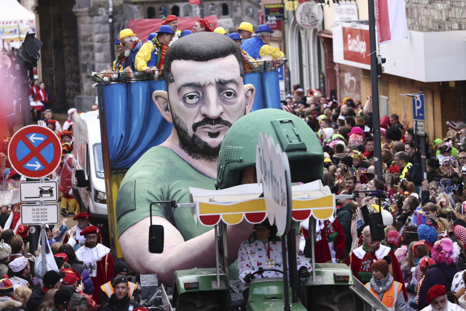 A float depicting Ukrainian President Volodymyr Zelenskyy is driven through the streets during the Rose Monday parade in Cologne, Germany, Monday, Feb. 12, 2024. (Rolf Vennenbernd/dpa via AP)