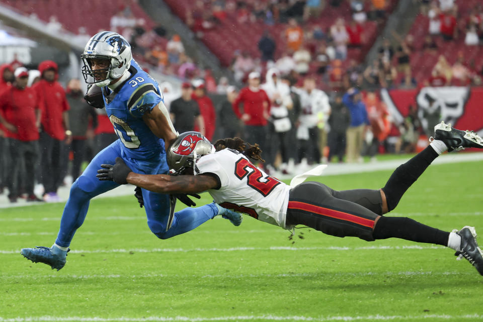 Carolina Panthers running back Chuba Hubbard runs past Tampa Bay Buccaneers safety Ryan Neal during the first half of an NFL football game Sunday, Dec. 3, 2023, in Tampa, Fla. (AP Photo/Mark LoMoglio)