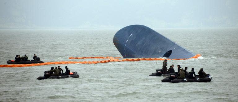 Coast Guard and Navy divers search for passengers near a South Korean ferry (C) that capsized on its way to Jeju island from Incheon, at sea some 20 kilometres off the island of Byungpoong in Jindo on April 17, 2014