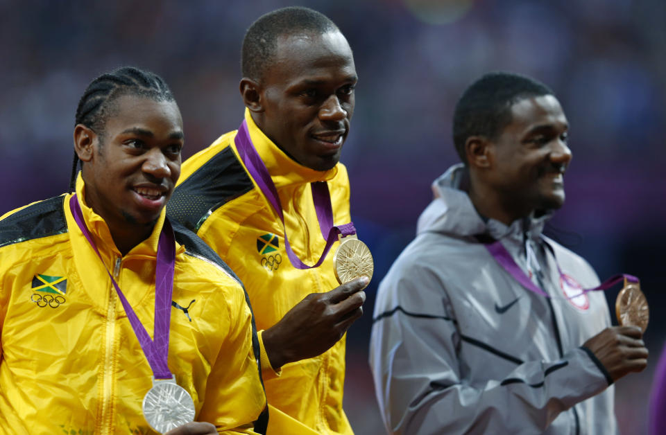 Gold medallist Jamaica's Usain Bolt poses with silver medallist Jamaica's Yohan Blake (L) and bronze medallist Justin Gatlin of the U.S. (R) during the men's 100m victory ceremony at the London 2012 Olympic Games at the Olympic Stadium August 6, 2012. REUTERS/Eddie Keogh (BRITAIN - Tags: OLYMPICS SPORT ATHLETICS) 