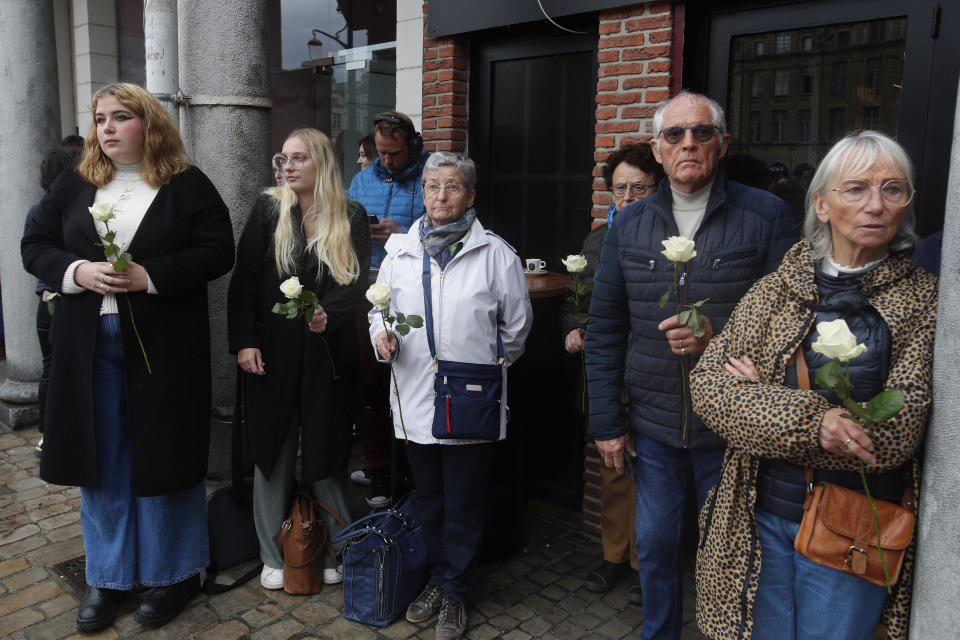 People pay tributes to French teacher Dominique Bernard during his funeral, in Arras, northern France, Thursday, Oct. 19, 2023. Bernard, 57, was stabbed to death at the school by a suspected Islamist extremist. (AP Photo/Michel Spingler)