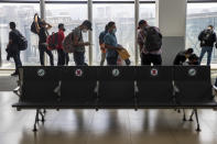 Passengers wait to board a humanitarian flight to Canada at the La Aurora international airport in Guatemala City, Thursday, Sept. 17, 2020. Authorities are preparing for the reopening of the airport on Friday as part of the gradual reopening of the country's borders by allowing national flights and some duly authorized international flights. (AP Photo/Moises Castillo)