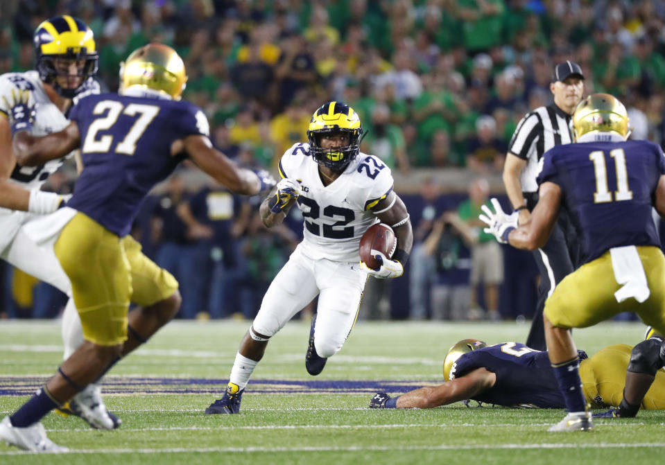Michigan running back Karan Higdon (22) cuts between Notre Dame cornerback Julian Love (27) and safety Alohi Gilman (11) in the first half of an NCAA football game in South Bend, Ind., Saturday, Sept. 1, 2018. (AP Photo/Paul Sancya)