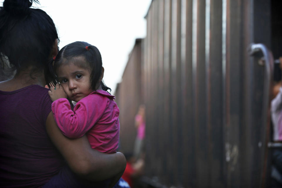 A migrant mother and child wait for a freight train to ride on their way north, in Salto del Agua, Chiapas state, Mexico, Monday, June 24, 2019. Mexico has deployed 6,500 National Guard members in the southern part of the country, plus another 15,000 soldiers along its northern border in a bid to reduce the number of migrants traveling through its territory to reach the U.S. (AP Photo/Marco Ugarte)